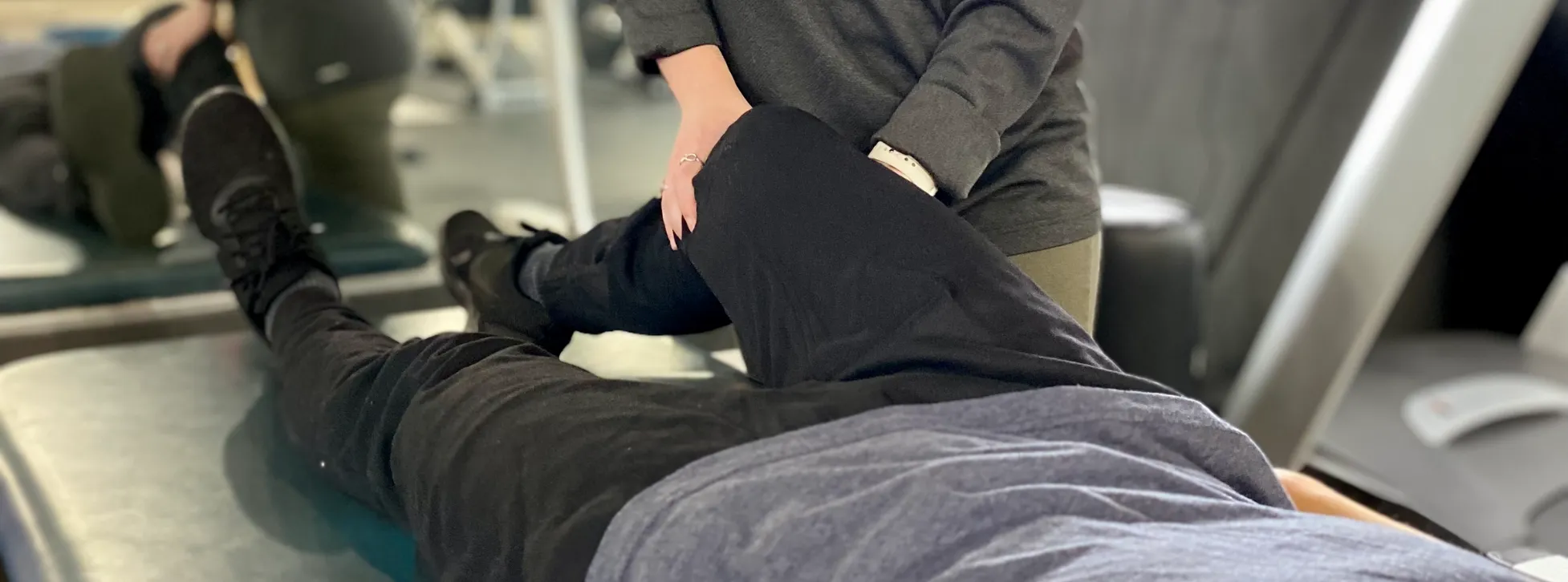 Therapist guiding a patient through post-surgical rehab