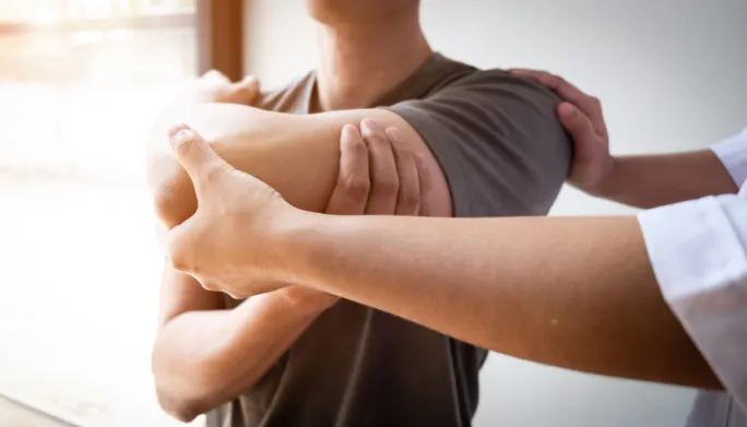 Physical therapist assessing a patient's movement and mobility