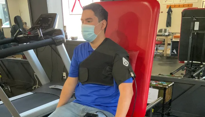 Patient wearing an electrical stimulation device on his shoulder in the clinic