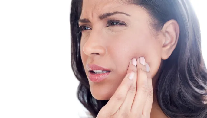 Woman touching her jaw in pain